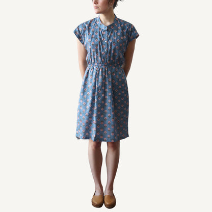 Woman wearing a blue floral dress on a white background