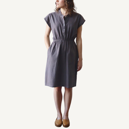 Woman wearing a gray dress on a white background