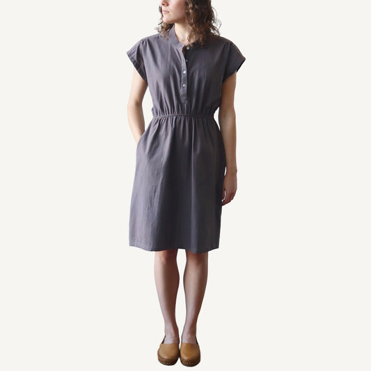 Woman wearing a gray dress on a white background