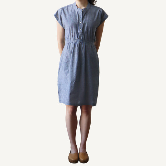 Person wearing a blue dress on a white background