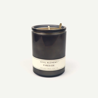 Gray candle with 'Civil Alchemy Fireside' label on a white background