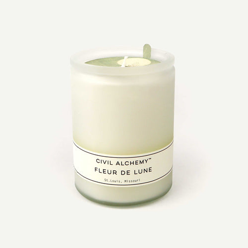 Candle labeled 'Civil Alchemy Fleur de Lune' on a white background