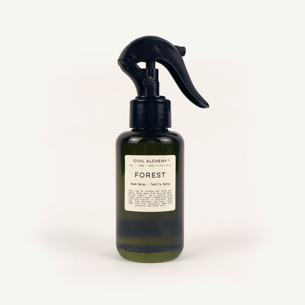 Green  spray bottle labeled 'Forest' by Civil Alchemy on a white background