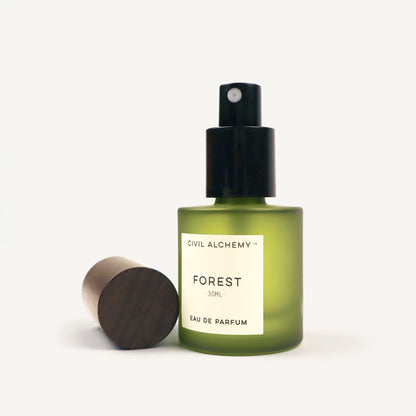 Green perfume bottle labeled 'Forest' by Civil Alchemy on a white background