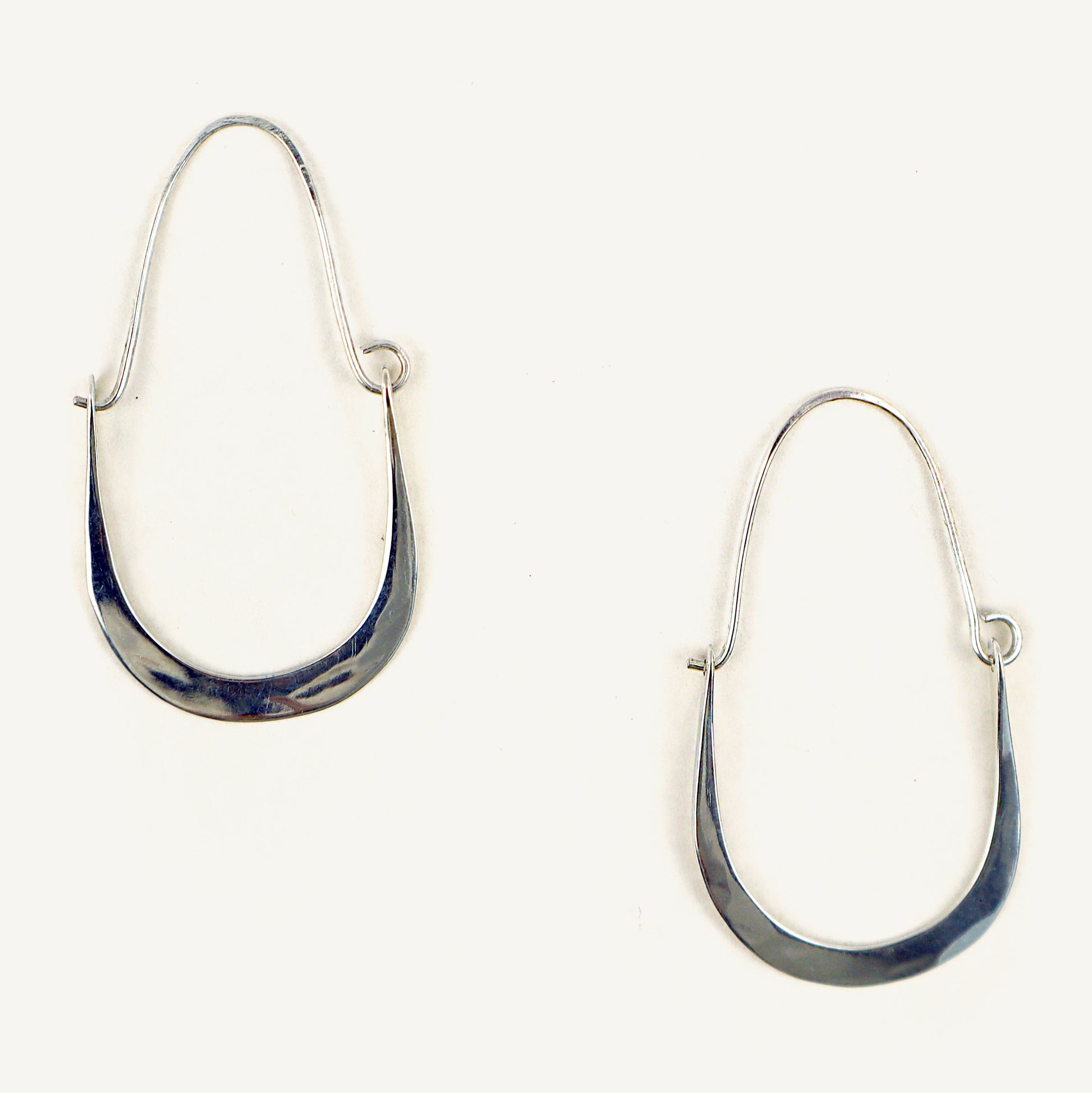 Silver hoop earrings on a white background