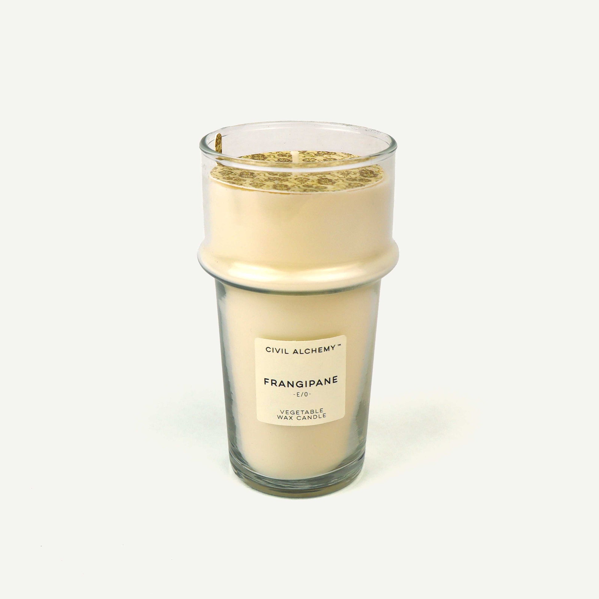 Candle labeled 'Frangipane' by Civil Alchemy on a white background