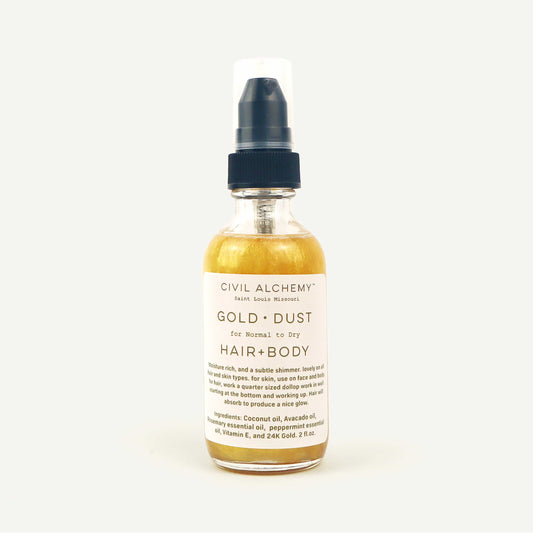 Bottle of Civil Alchemy Gold Dust Hair and Body Oil on a white background