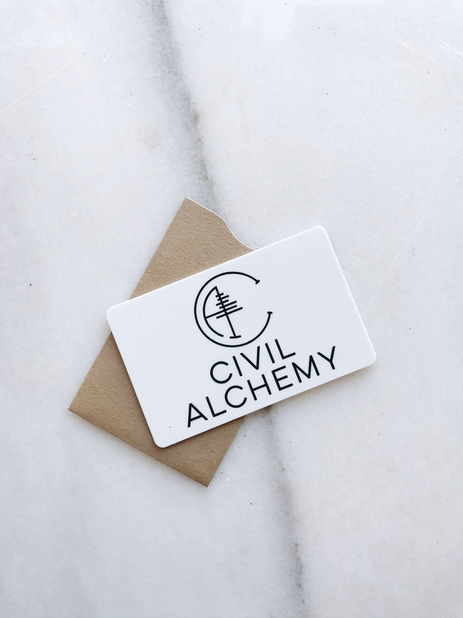 Card with 'Civil Alchemy' logo on a marble surface