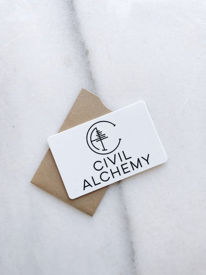 Card with 'Civil Alchemy' logo on a marble surface