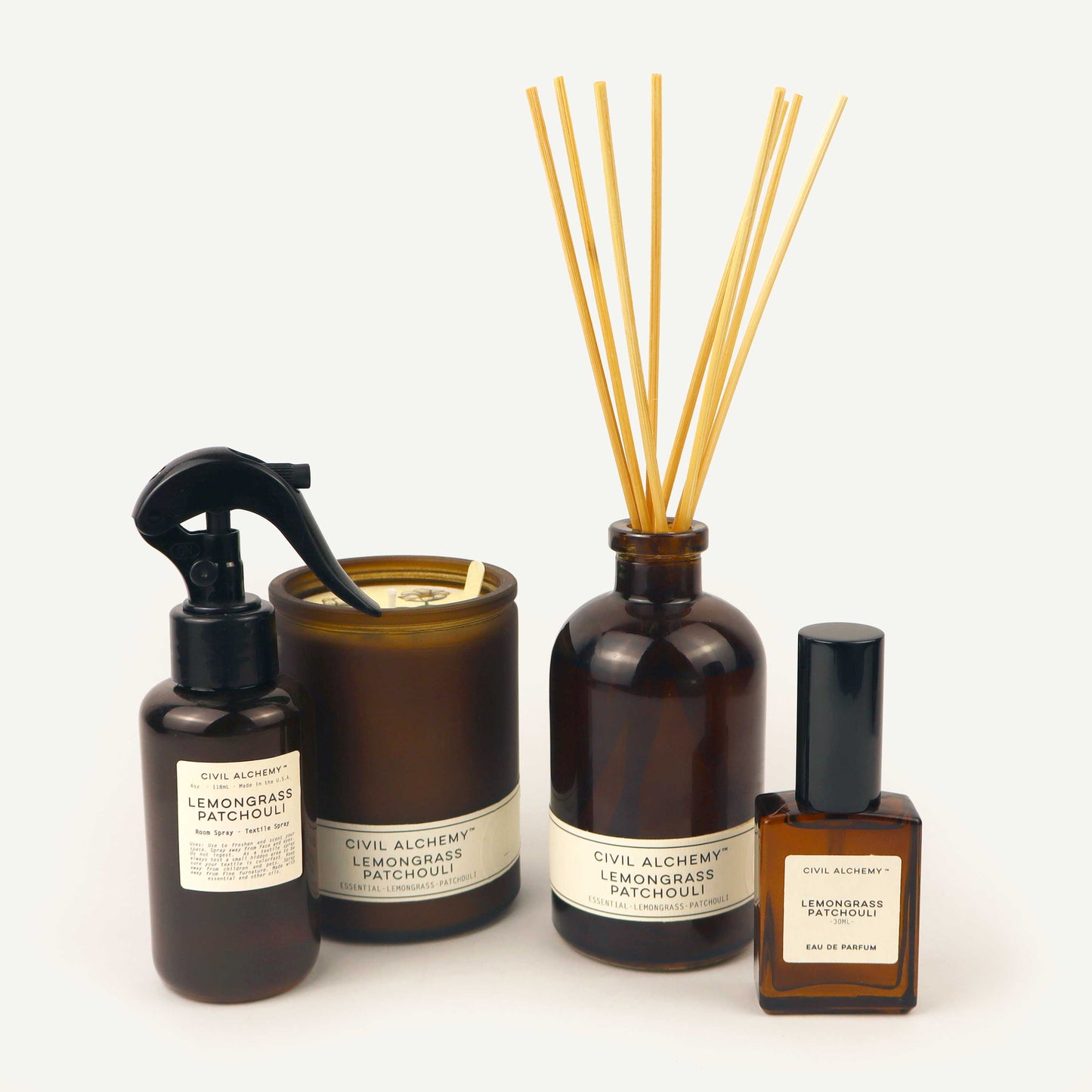 Set of diffusers and candles with lemongrass patchouli scent on a white background