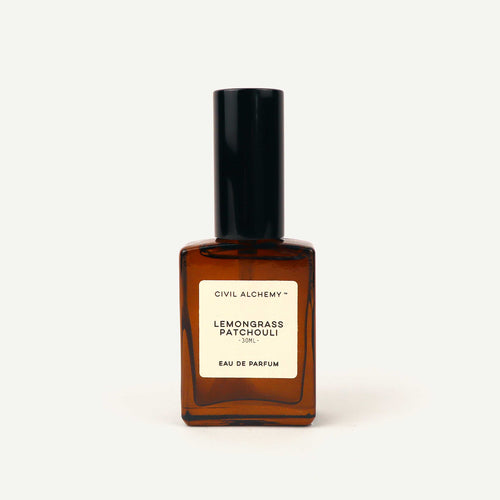 Brown perfume bottle with black cap on a white background