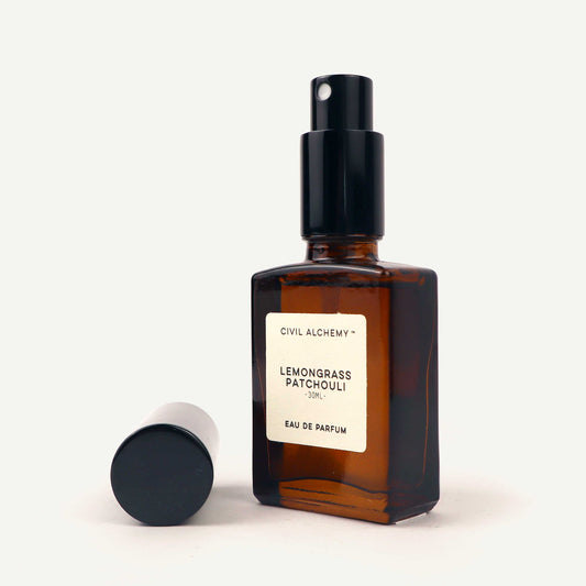 Brown perfume bottle with a black cap on a white background