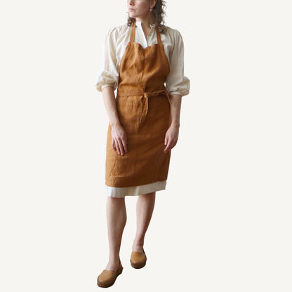 Person wearing a hazelnut apron on a white background