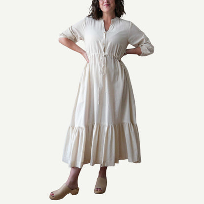Woman wearing a white dress on a plain background