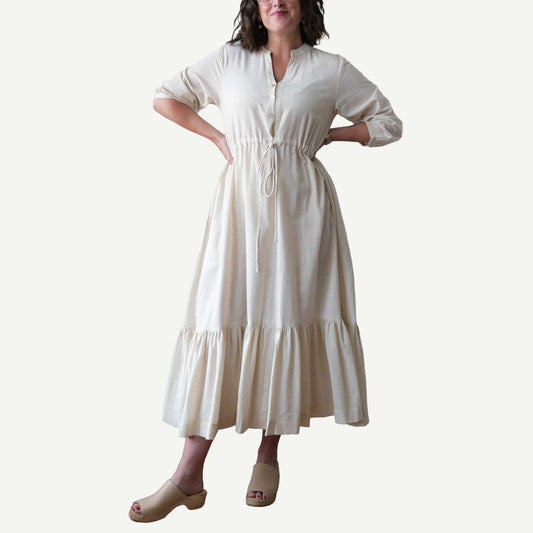 Woman wearing a white dress on a plain background