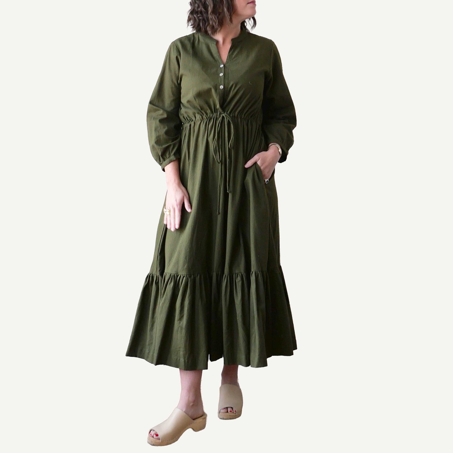 Woman wearing a green dress on a white background