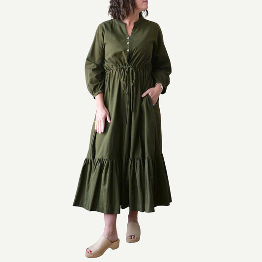 Woman wearing a green dress on a white background