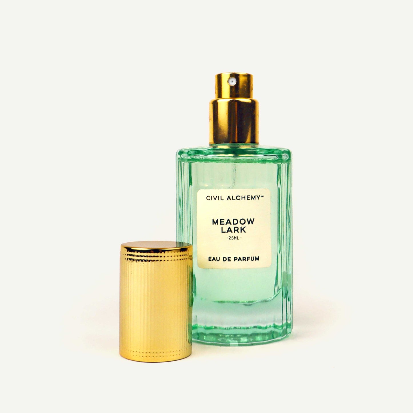 Green perfume bottle with gold cap on a white background