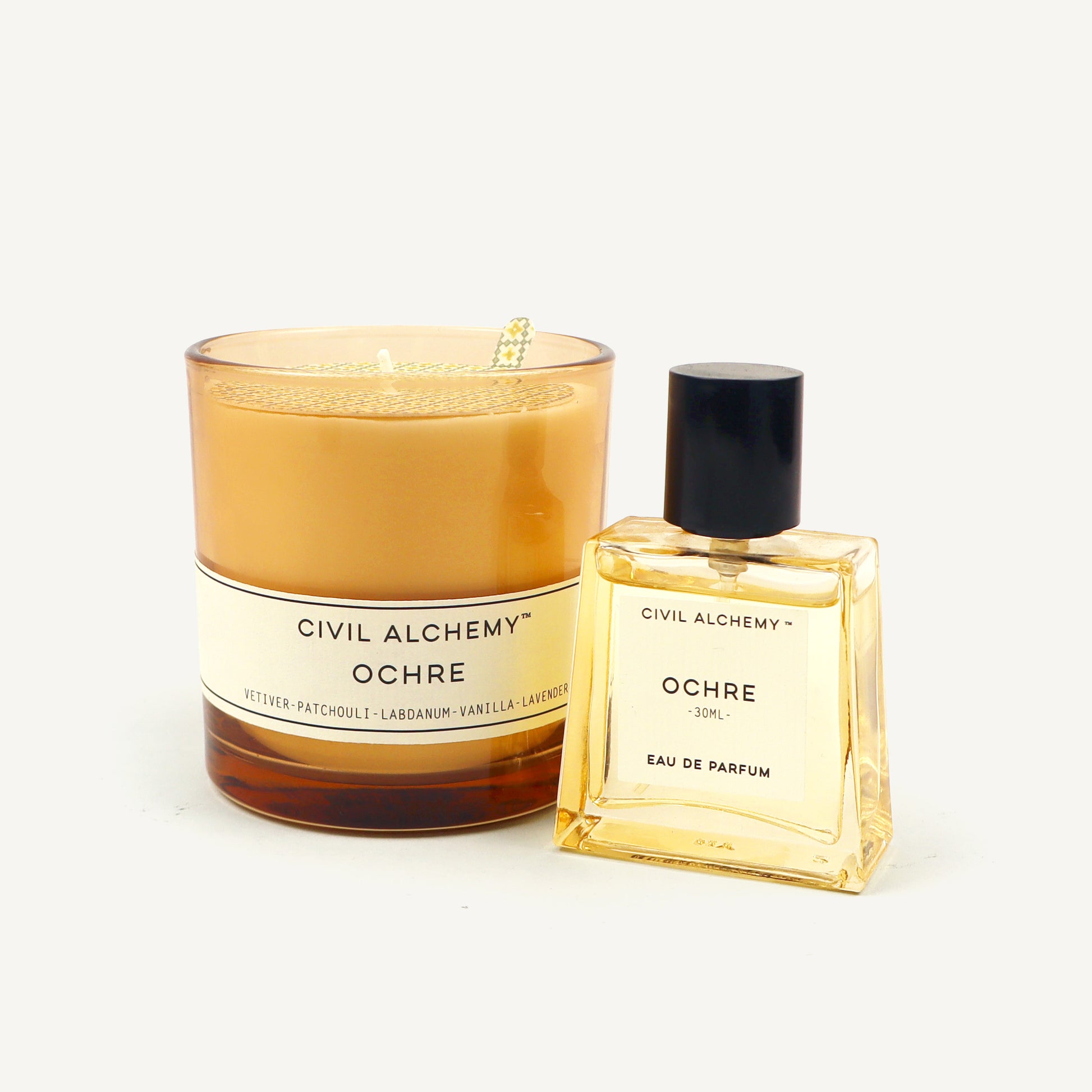 Candle and perfume bottle labeled 'Ochre' by Civil Alchemy on a light background
