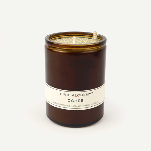 Brown candle with a white label on a white background