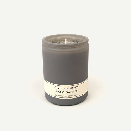 Gray candle with a white label on a white background