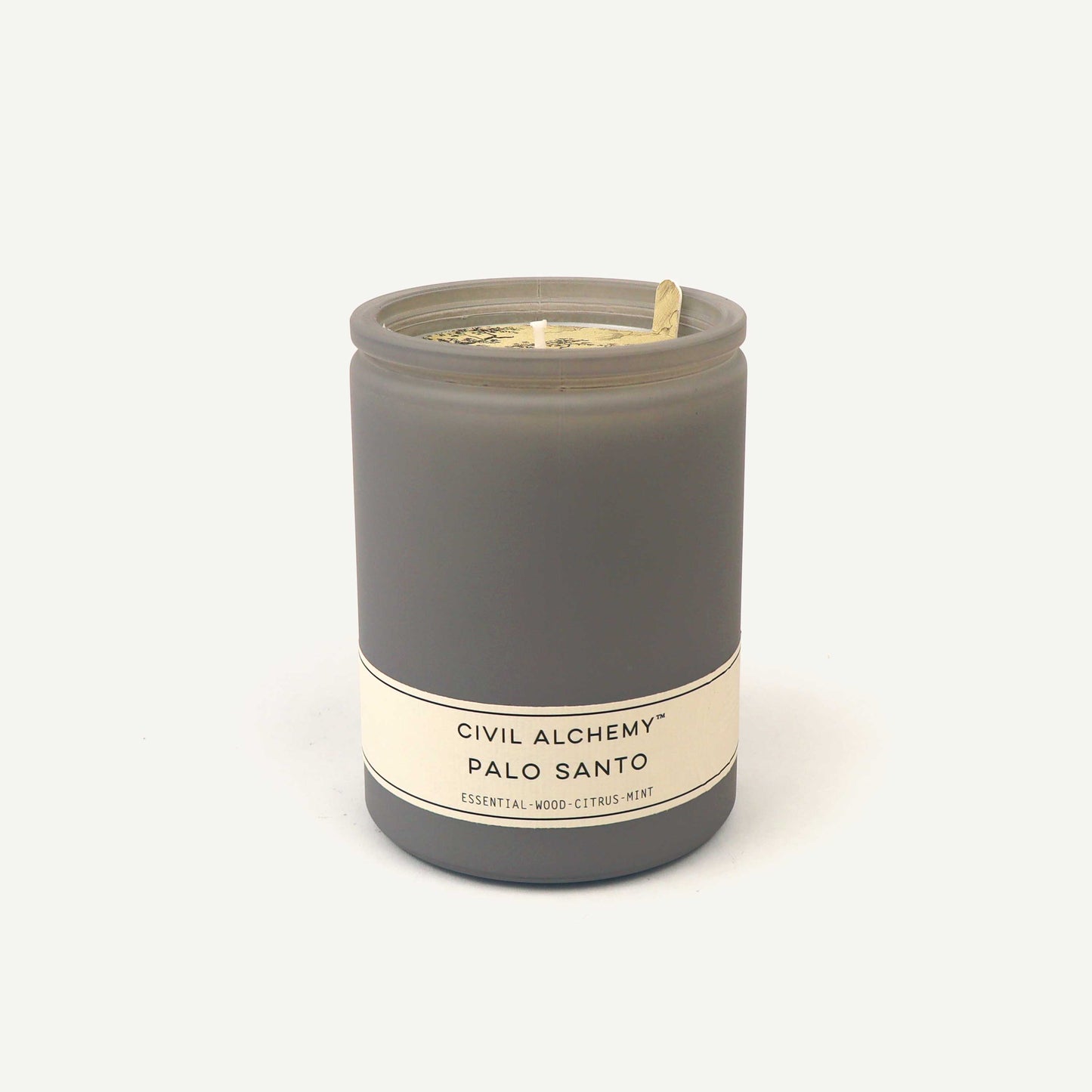 Gray candle with a label on a white background