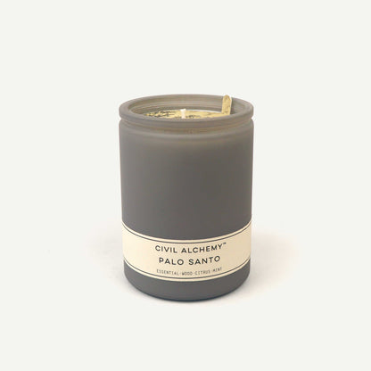 Gray candle with a label on a white background