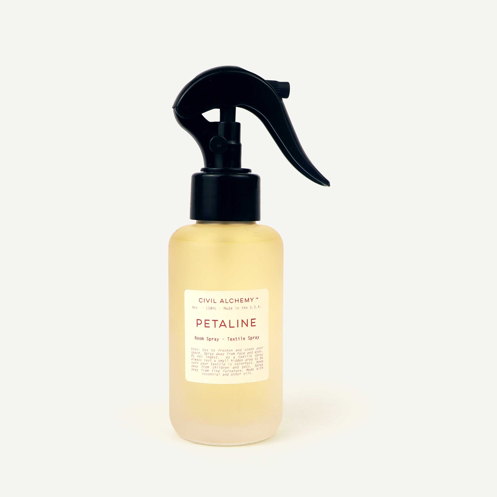 Spray bottle labeled 'Petaline' by Civil Alchemy on a white background
