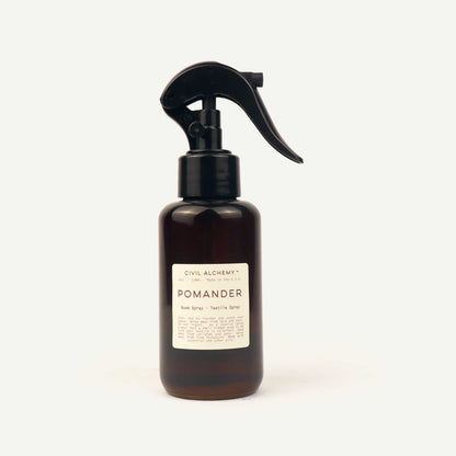 Brown spray bottle labeled 'Pomander' on a white background