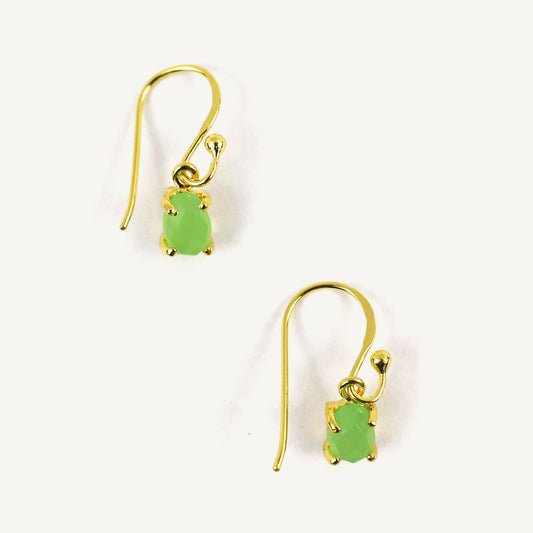 Gold earrings with green gemstones on a white background