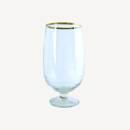 A clear glass beer mug with a gold rim on the top edge.