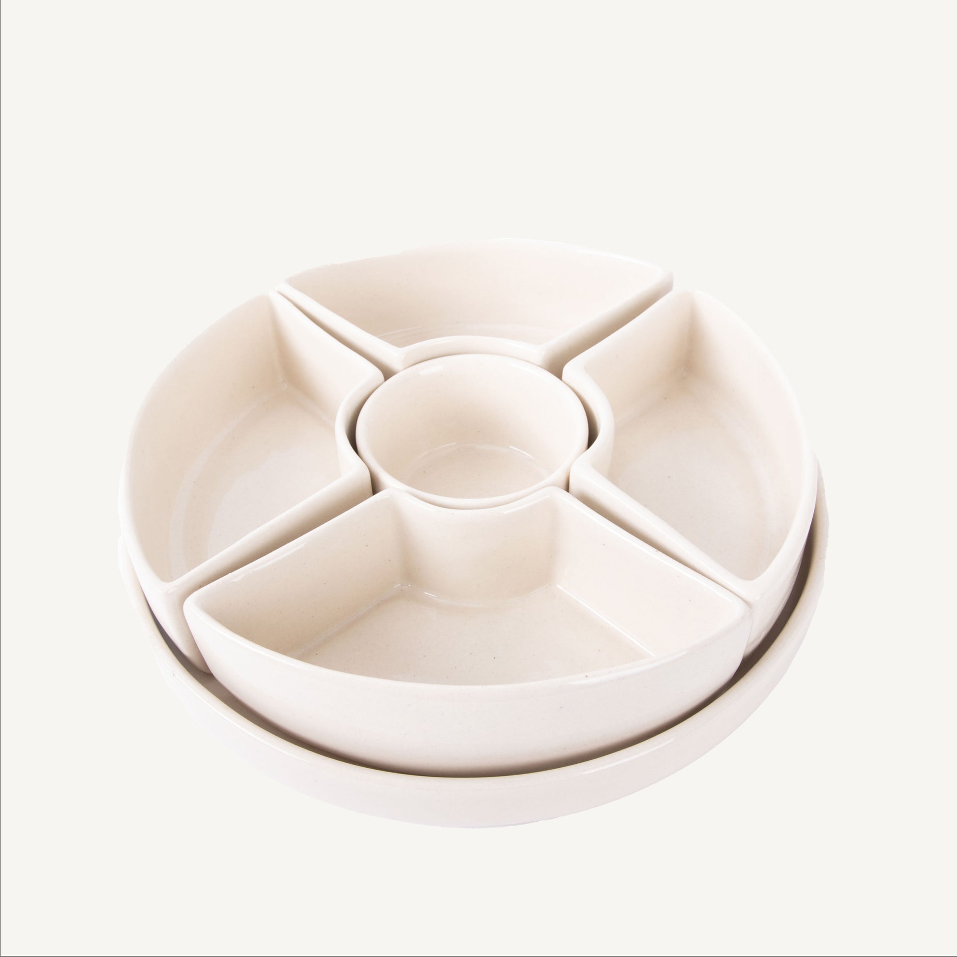 Round beige ceramic tray with compartments on a white background