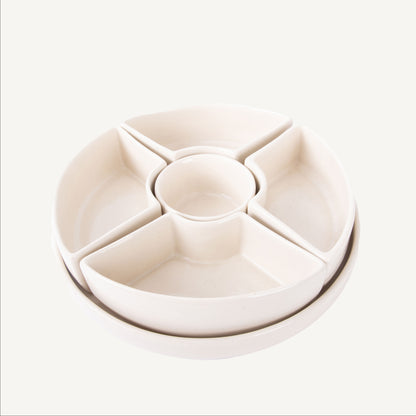Round beige ceramic tray with compartments on a white background