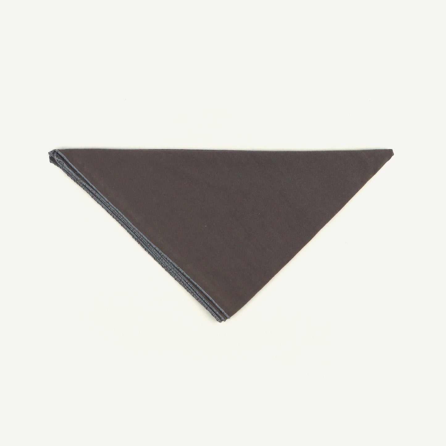 Dark gray triangular fabric sample on a white background
