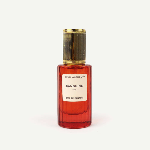 Red perfume bottle with gold cap on a white background