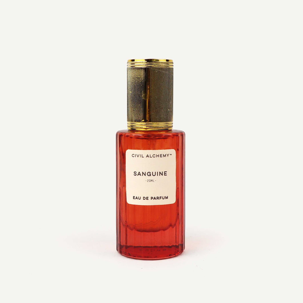 Red perfume bottle with gold cap on a white background