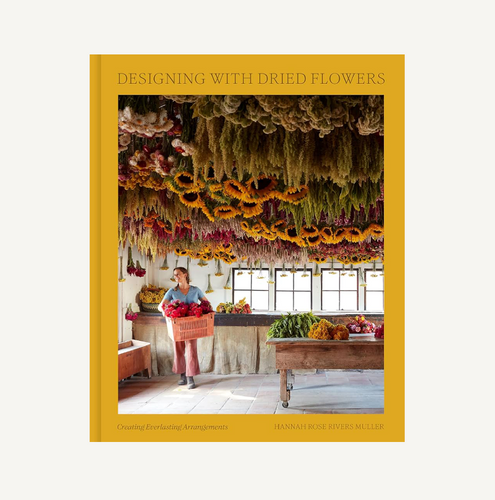 Book cover titled 'Designing with Dried Flowers' featuring a person in a room with dried flower arrangements.