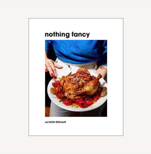 Book cover of 'nothing fancy' by Alison Roman with a roasted chicken on a plate.