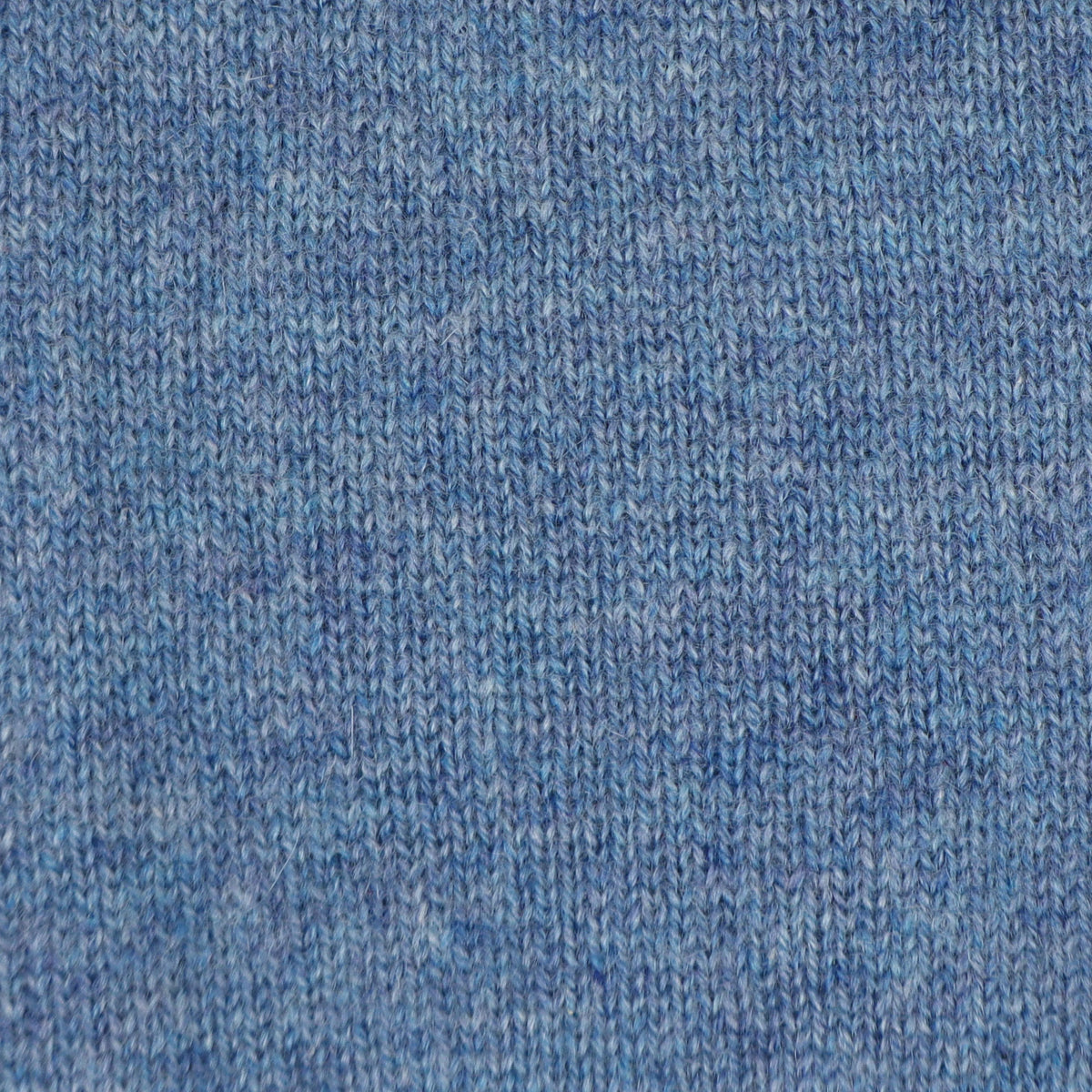 A close-up of a blue knit fabric texture, showing the detailed ribbed pattern and heathered weave.