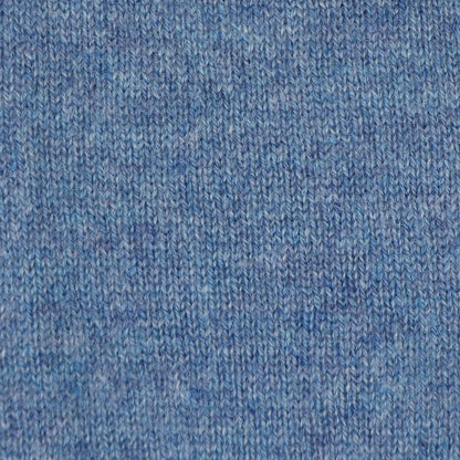 A close-up of a blue knit fabric texture, showing the detailed ribbed pattern and heathered weave.