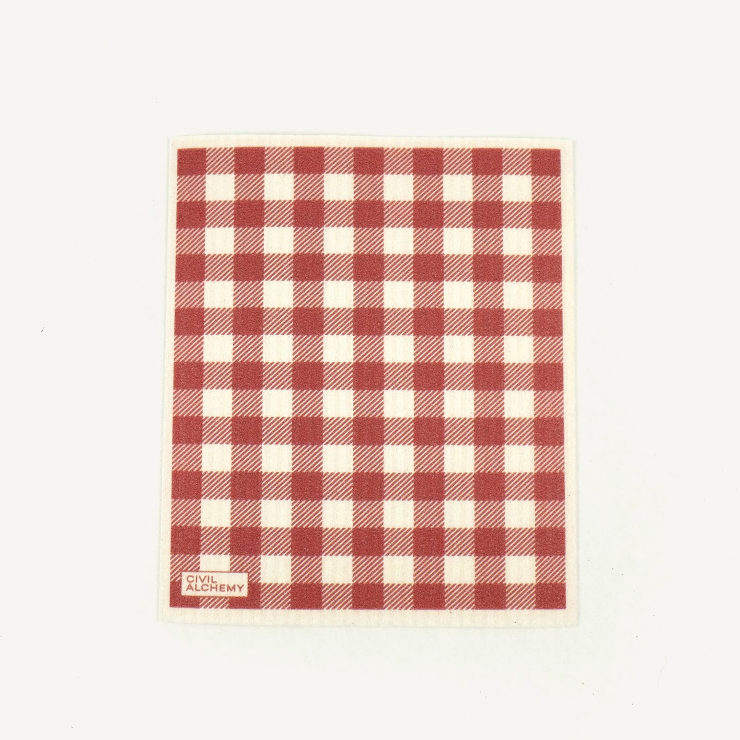 Red and white checkered towel with 'Civil Alchemy' branding on a light beige background