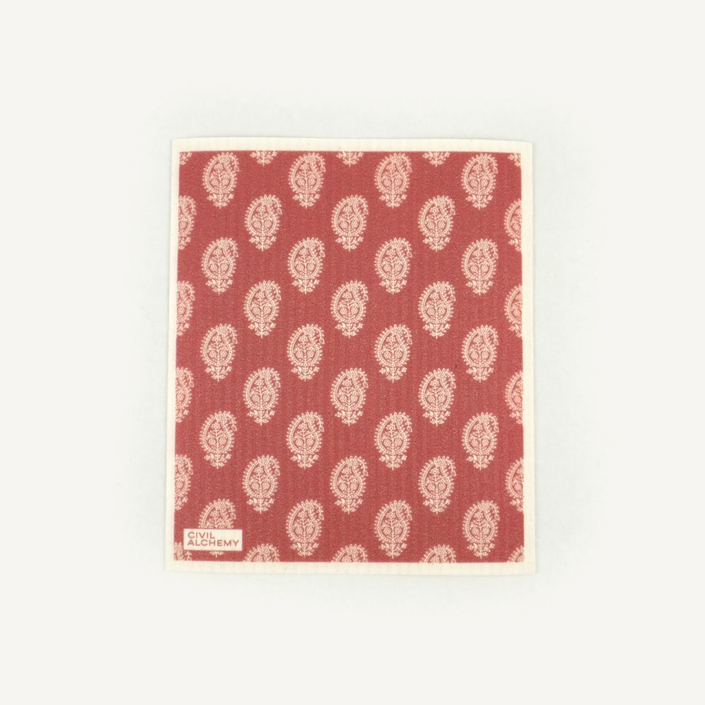 Red Swedish dishcloth with white floral pattern on a white background