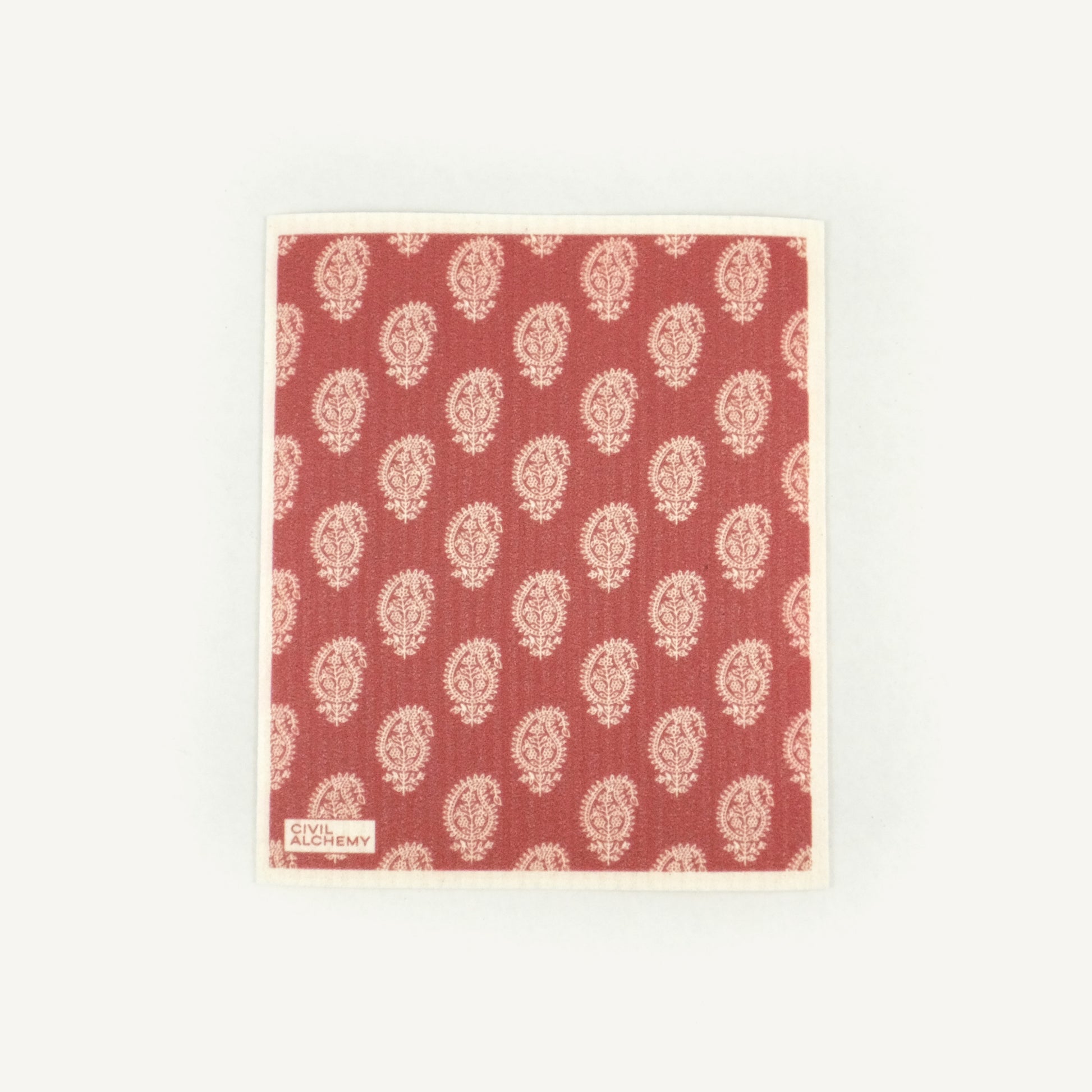 Red Swedish dishcloth with white floral pattern on a white background