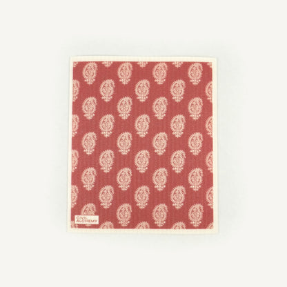 Red Swedish dishcloth with white floral pattern on a white background