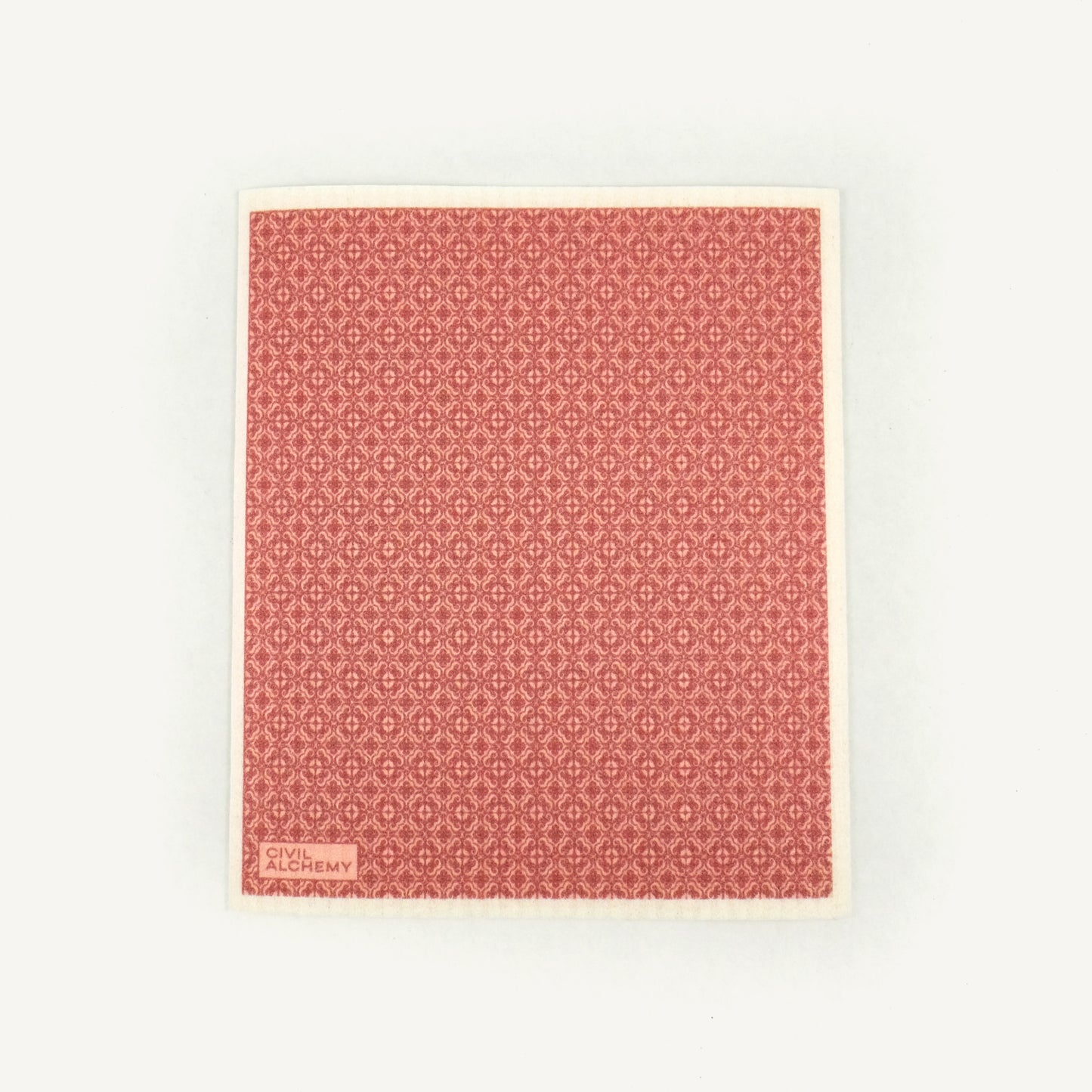 Pink patterned Swedish dishcloth on a white background