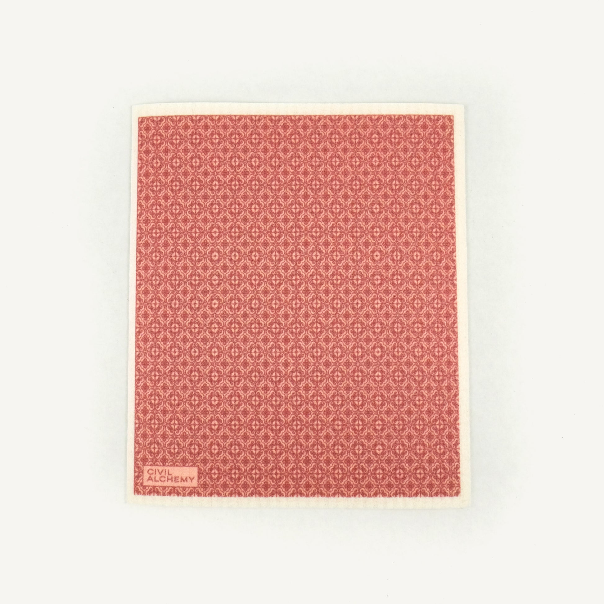 Pink patterned Swedish dishcloth on a white background