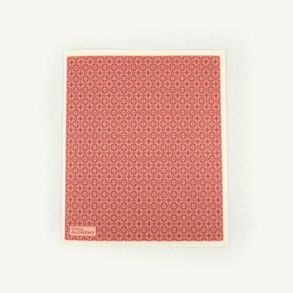 Pink patterned Swedish dishcloth on a white background