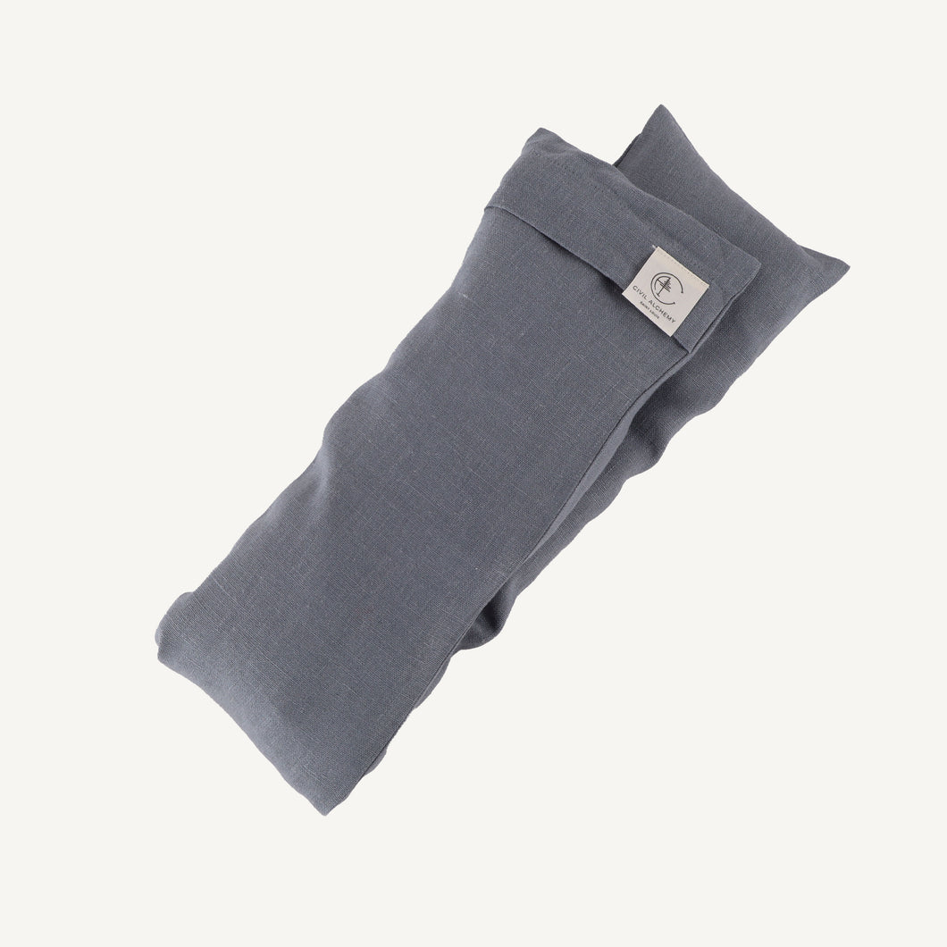 Folded blue fabric with a brand label on a white background