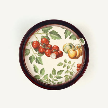 Decorative candle topper with tomato and leaf design on a white background