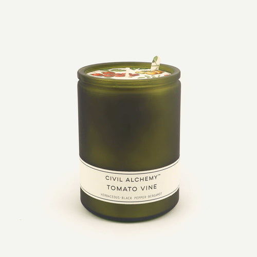 Green candle with a label on a white background